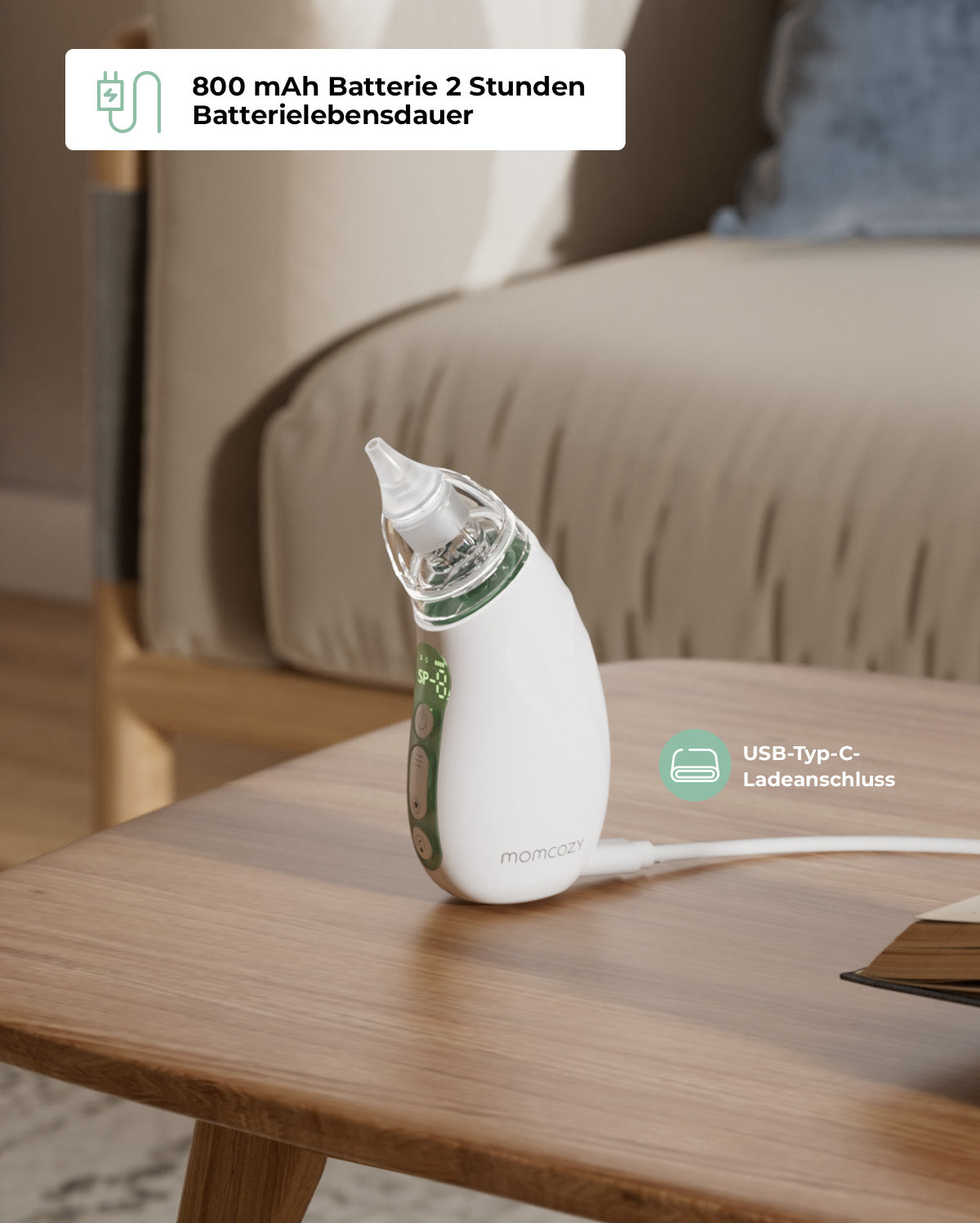 Momcozy Baby Nasal Aspirator with USB Type-C port and 800 mAh battery on a wooden table.