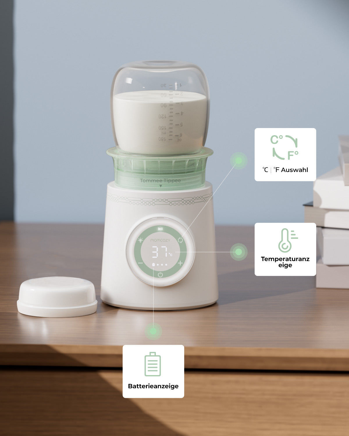 Cordless portable baby bottle warmer with temperature and battery displays on a table.