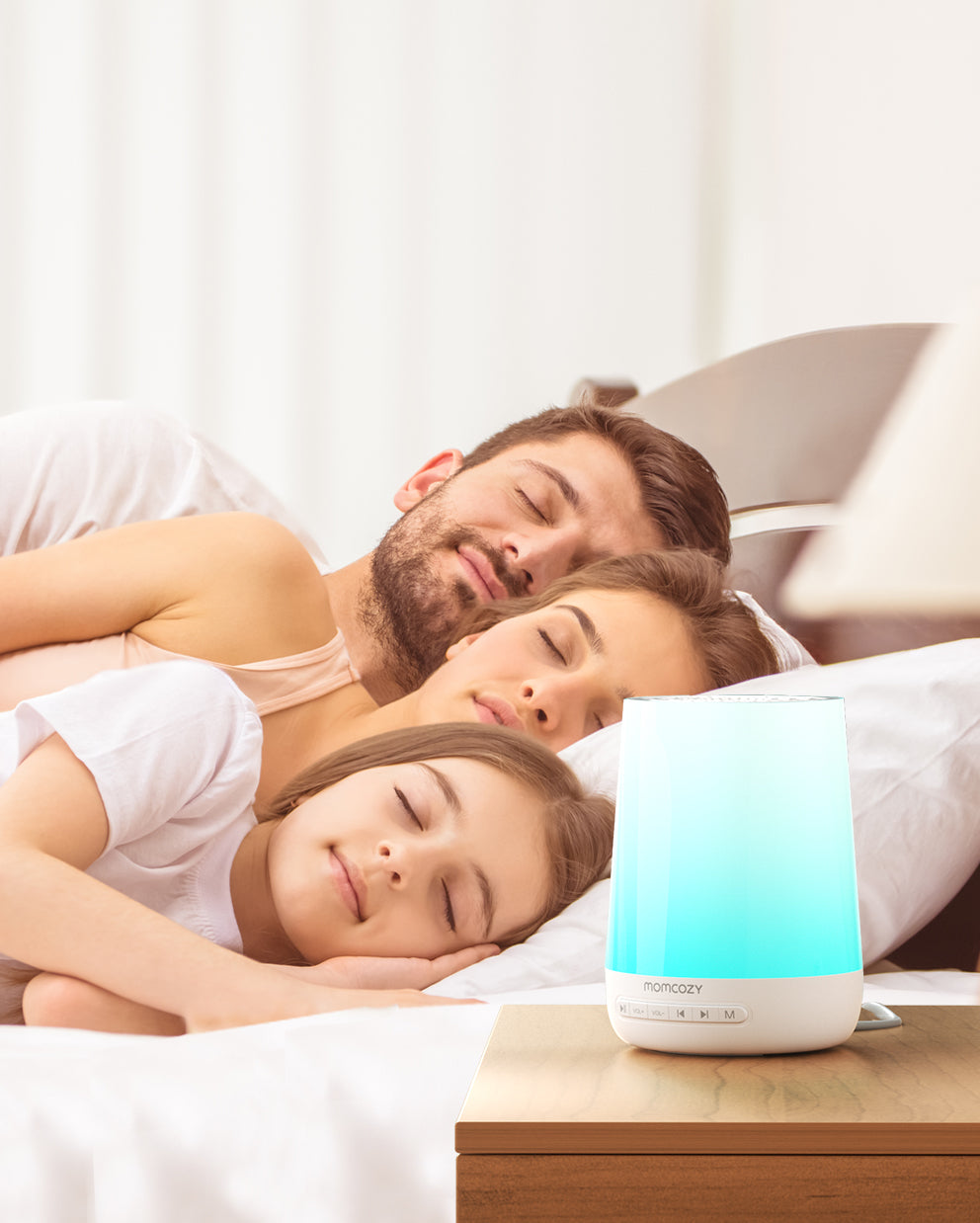 Family peacefully sleeping by the Momcozy Smart Baby Sound Machine with calming blue light.